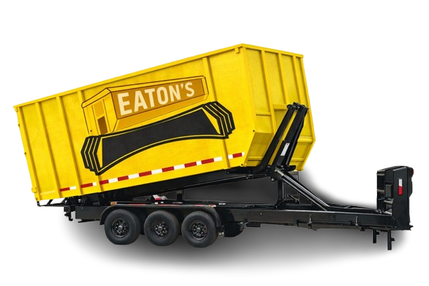 Eaton’s yellow roll-off dumpster trailer raised for unloading, heavy-duty construction and renovation waste container.